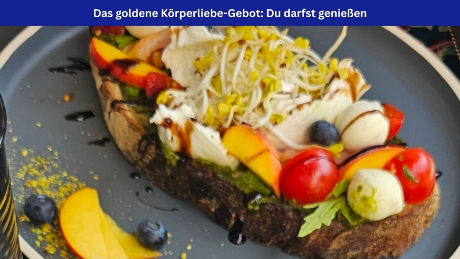 Ein wunderschön und abwechslungsreich belegtes vegetarisches Brot auf einem grauen Teller. Darüber ein blaues Banner mit der Aufschrift: Das goldene Körperliebe-Gebot: Du darfst genießen.